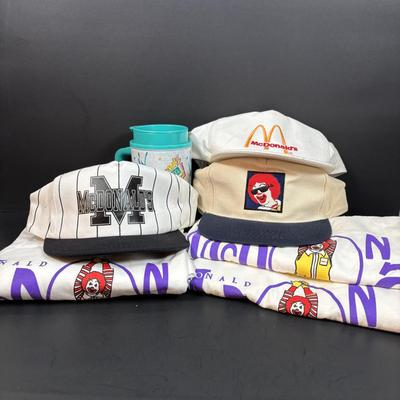 LOT 152: Vintage Ronald McDonald T-Shirts (qty 3, M, L, XL), Mc Donalds Hat and a Thermo Whirly Cup