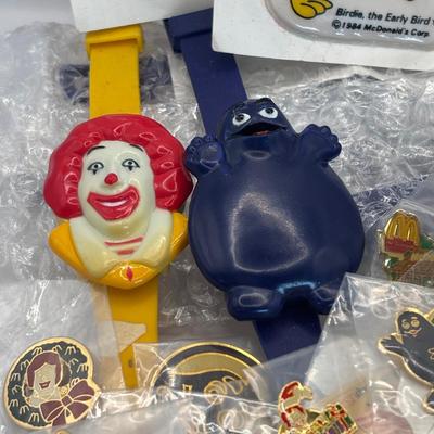 LOT 334: McDonalds Collection: Ronald McDonald & Grimace Digital Watches, NIP Lapel Pins & More