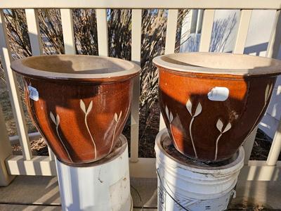 Two matching beautiful clay pottery flowerpots with leaf designs