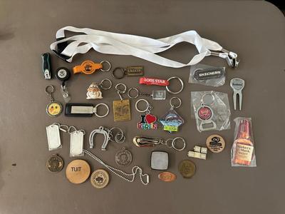 A COLLECTION OF KEYCHAINS, LANYARDS AND MORE