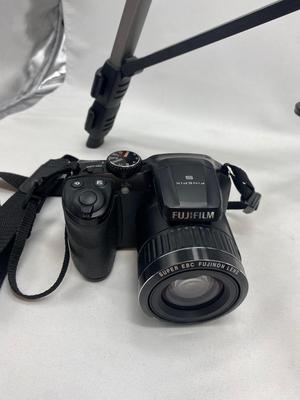 FUJI DIGITAL CAMERA IN A CASE AND A TRIPOD