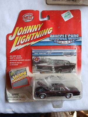 Three Johnny Lightning collectable cars