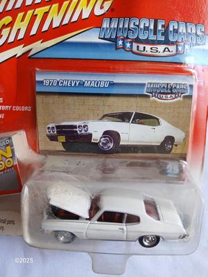 Three Johnny Lightning collectable cars