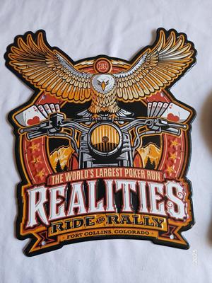 Tin Harley Realities ride and Rally sign Fort Collins, Co. with wooden Harley Davidson motor oils sign with hooks