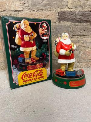 Sale Photo Thumbnail #219: Watch Santa take a refreshing drink of Coke while you send the train around his feet