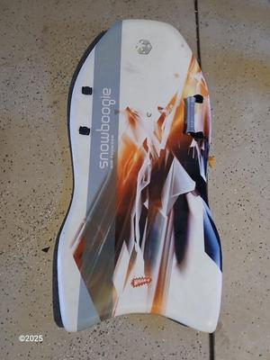 Two sleds - orange disk sled and a Snow boogie board