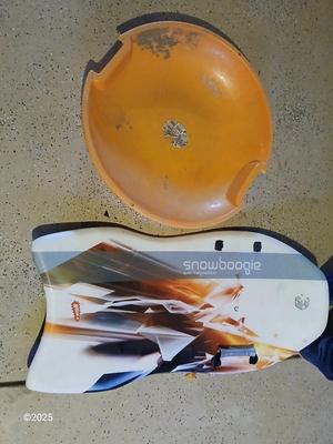 Two sleds - orange disk sled and a Snow boogie board