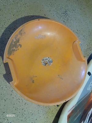 Two sleds - orange disk sled and a Snow boogie board