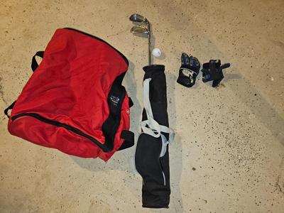 Sports bag with child's size rollerblades - Safety gear - and a few small golf clubs