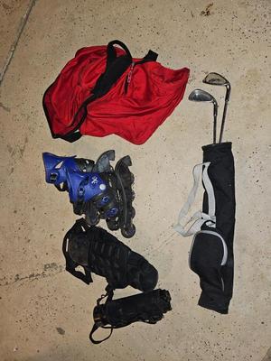 Sports bag with child's size rollerblades - Safety gear - and a few small golf clubs