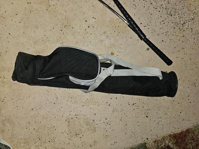 Sports bag with child's size rollerblades - Safety gear - and a few small golf clubs