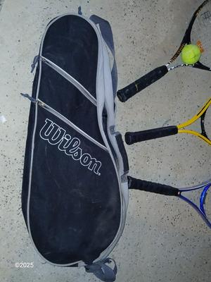 Three tennis racquets with a Wilson tennis racquet bag