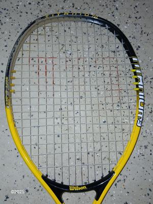 Three tennis racquets with a Wilson tennis racquet bag