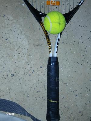 Three tennis racquets with a Wilson tennis racquet bag