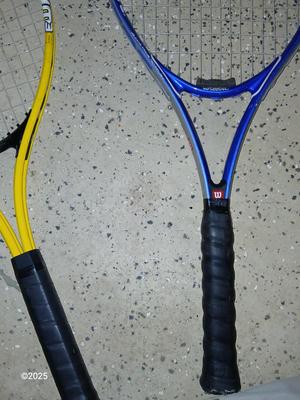 Three tennis racquets with a Wilson tennis racquet bag