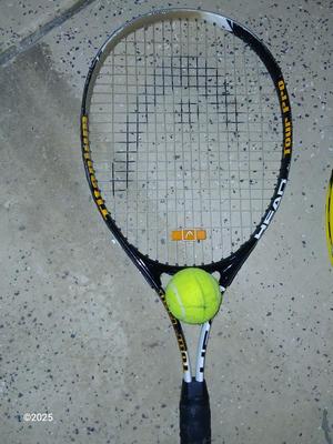 Three tennis racquets with a Wilson tennis racquet bag