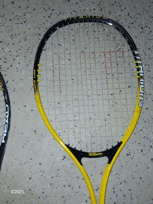 Three tennis racquets with a Wilson tennis racquet bag