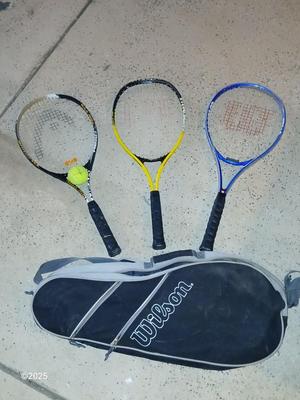 Three tennis racquets with a Wilson tennis racquet bag