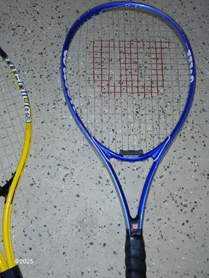 Three tennis racquets with a Wilson tennis racquet bag