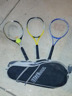 Three tennis racquets with a Wilson tennis racquet bag