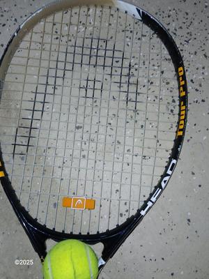 Three tennis racquets with a Wilson tennis racquet bag