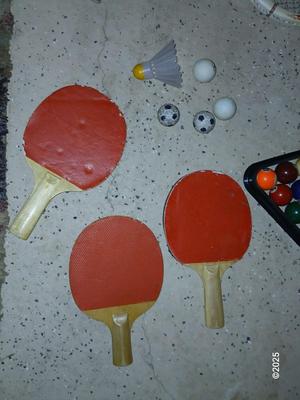 Racquets, paddles with pong balls and a small set of Pool balls