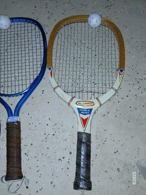 Racquets, paddles with pong balls and a small set of Pool balls
