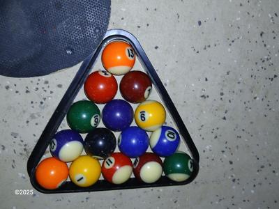 Racquets, paddles with pong balls and a small set of Pool balls