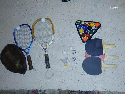 Racquets, paddles with pong balls and a small set of Pool balls