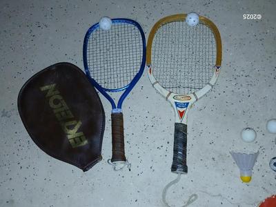 Racquets, paddles with pong balls and a small set of Pool balls