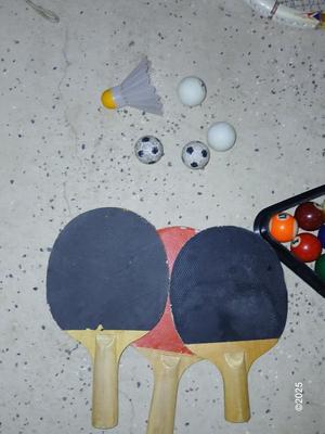 Racquets, paddles with pong balls and a small set of Pool balls