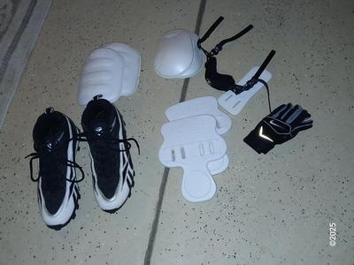 A nice pair of NFL size 9 cleats pads and Nike gloves