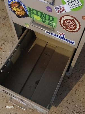 Metal filing cabinet - full of such cool local stickers