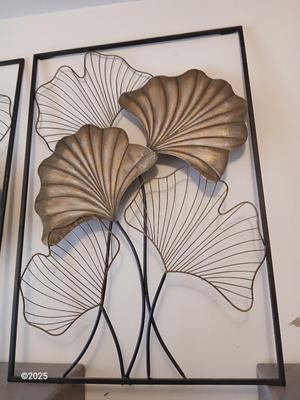 Two matching light metal wall art