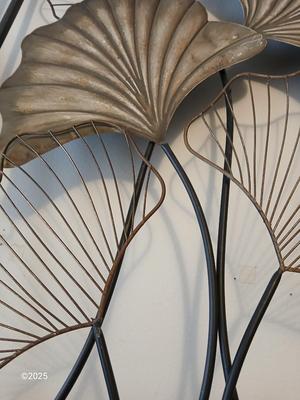 Two matching light metal wall art
