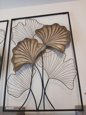 Two matching light metal wall art