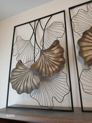 Two matching light metal wall art