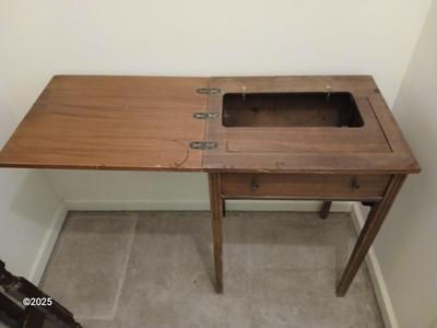 Old sewing cabinet and a old wooden twin sized headboard and footboard