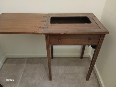Old sewing cabinet and a old wooden twin sized headboard and footboard