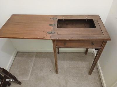 Old sewing cabinet and a old wooden twin sized headboard and footboard
