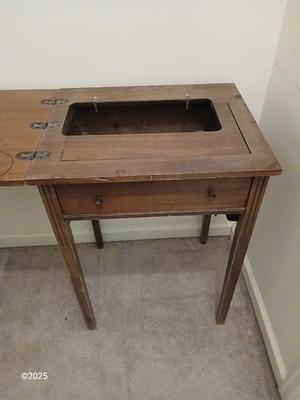 Old sewing cabinet and a old wooden twin sized headboard and footboard
