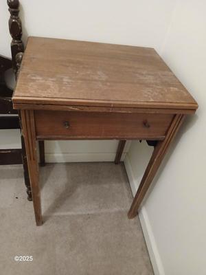 Old sewing cabinet and a old wooden twin sized headboard and footboard