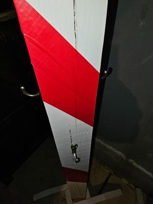 Two candy cane stripe posts with hooks and a box of Christmas light strands