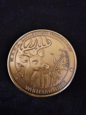 North American hunting Club books and a Collectors series coin