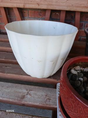 Three planters / flowerpots with a hose watering attachment