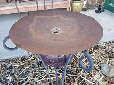 Neat handmade rustic plant stand with bowling ball center and a heavy metal Dragonfly Trellis