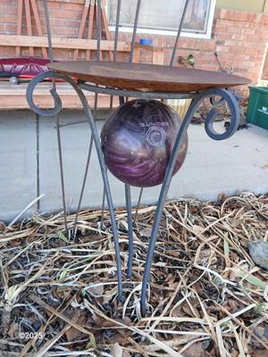Neat handmade rustic plant stand with bowling ball center and a heavy metal Dragonfly Trellis