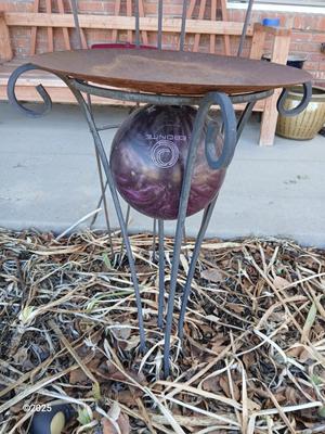 Neat handmade rustic plant stand with bowling ball center and a heavy metal Dragonfly Trellis