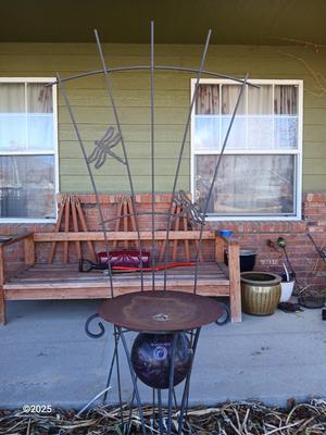 Neat handmade rustic plant stand with bowling ball center and a heavy metal Dragonfly Trellis