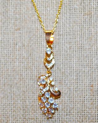 Graphic Designed Flowery PENDANT (2" x ¾") with 10 Larger Round Clear Stones on a Gold Tone Necklace Chain 18" L